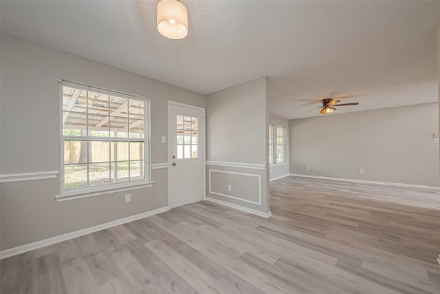 unfurnished room with ceiling fan and light hardwood / wood-style flooring