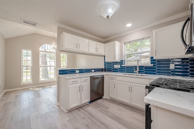 kitchen with plenty of natural light, light wood-type flooring, appliances with stainless steel finishes, and kitchen peninsula