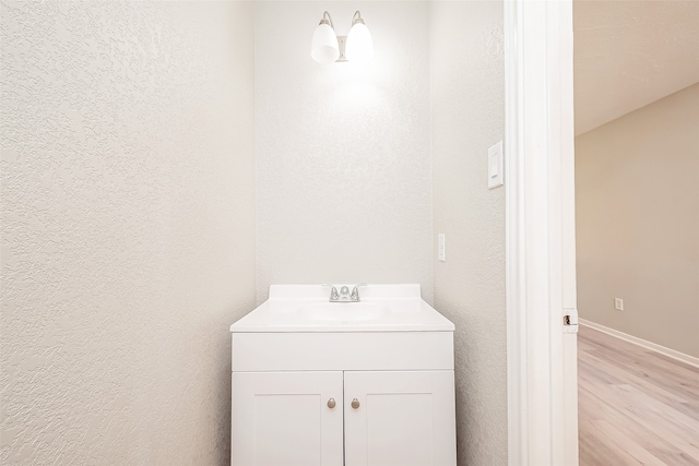 bathroom featuring vanity and hardwood / wood-style floors