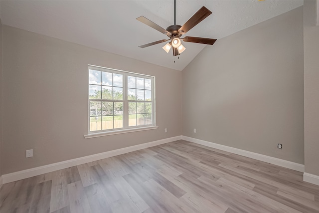 spare room with light hardwood / wood-style floors, lofted ceiling, and ceiling fan