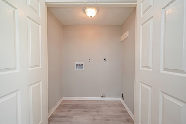 laundry room featuring hookup for a gas dryer, light hardwood / wood-style flooring, hookup for a washing machine, hookup for an electric dryer, and a textured ceiling