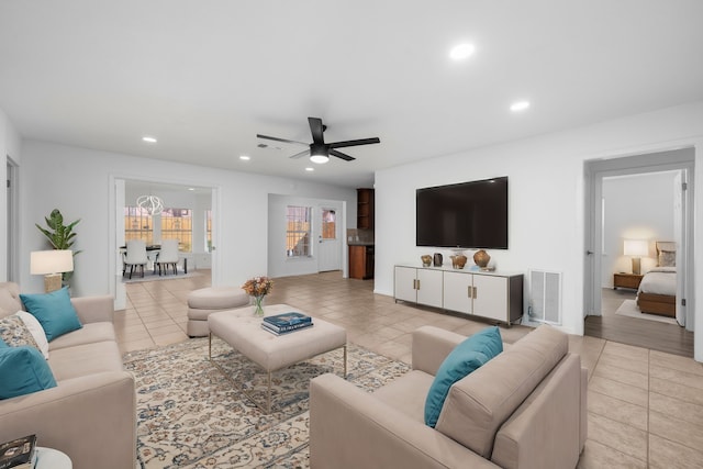 living room featuring ceiling fan and light tile patterned flooring