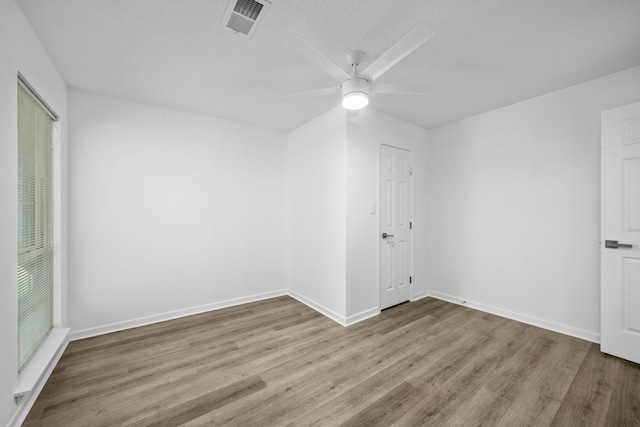 spare room with light hardwood / wood-style flooring and ceiling fan