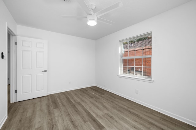 empty room with wood-type flooring and ceiling fan