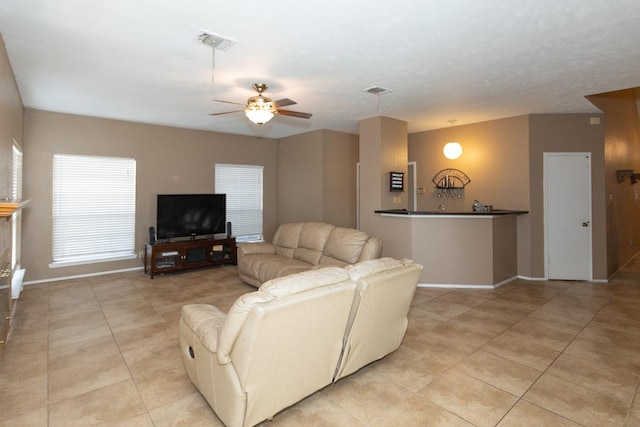 living room with ceiling fan and light tile patterned floors