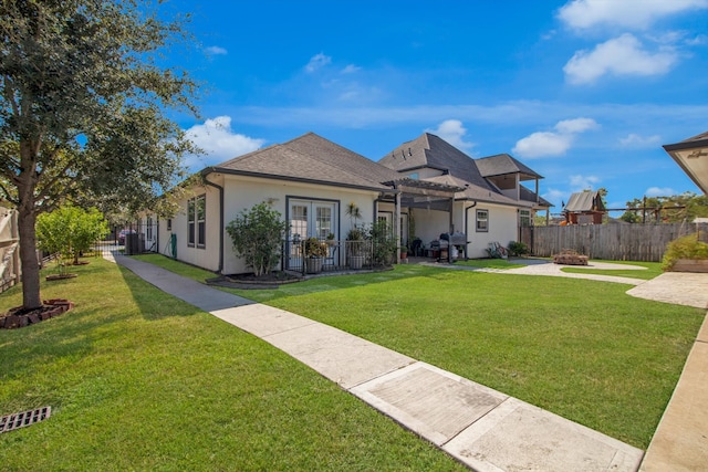 view of front of house with a patio area and a front yard