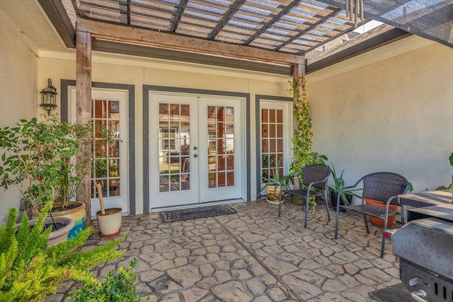 property entrance featuring a patio, french doors, and a pergola