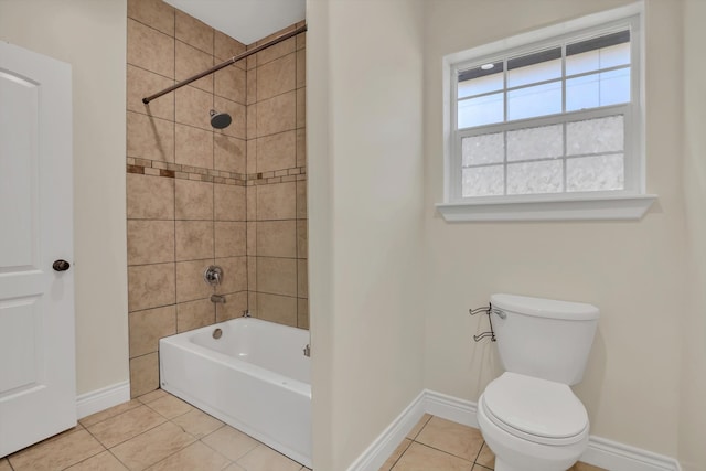 bathroom with toilet, tile patterned floors, and tiled shower / bath