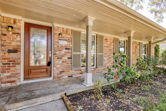 view of exterior entry featuring a porch