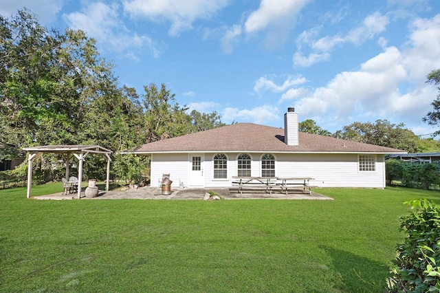 back of property featuring a yard and a patio