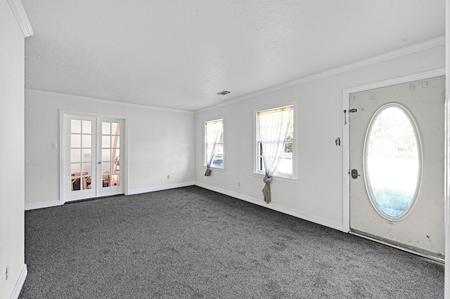 entryway featuring crown molding, dark carpet, and a textured ceiling