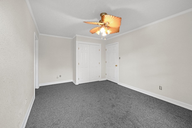 unfurnished bedroom with a closet, dark carpet, ceiling fan, and ornamental molding