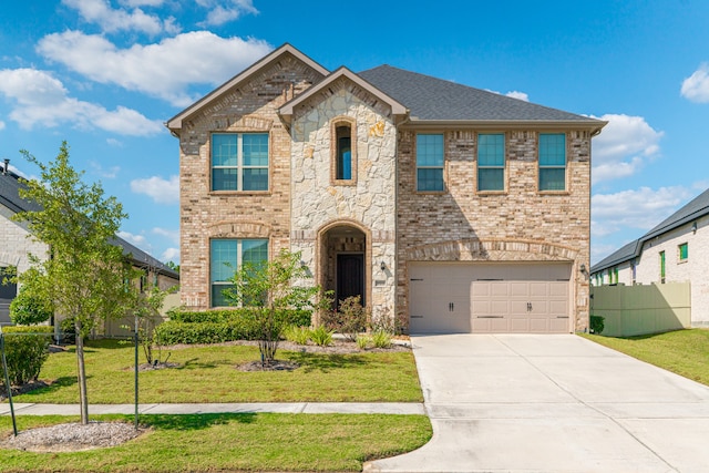 view of front of home featuring a front yard and a garage