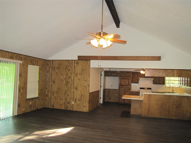 kitchen featuring vaulted ceiling with beams, dark hardwood / wood-style floors, wooden walls, and white range oven