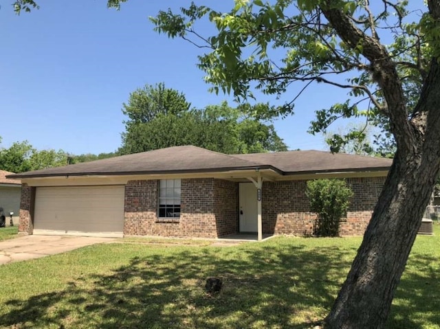 ranch-style house featuring a garage and a front lawn