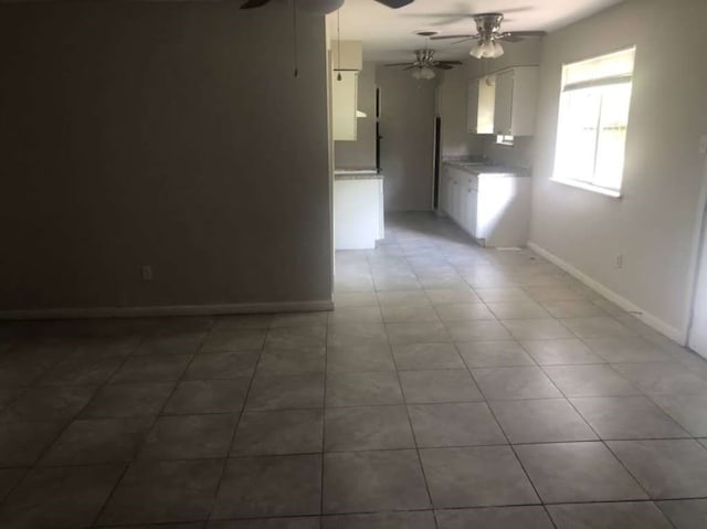 spare room with ceiling fan and tile patterned flooring