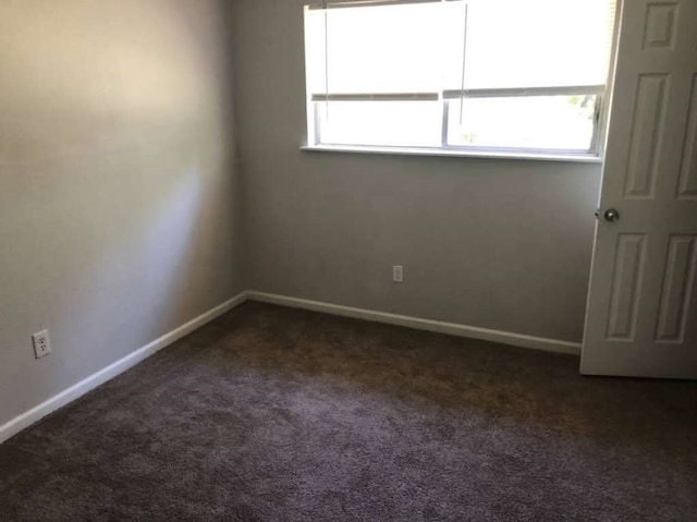 carpeted spare room featuring plenty of natural light