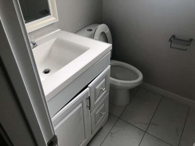 bathroom with vanity and toilet