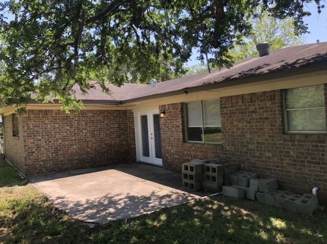 rear view of house featuring french doors and a patio area