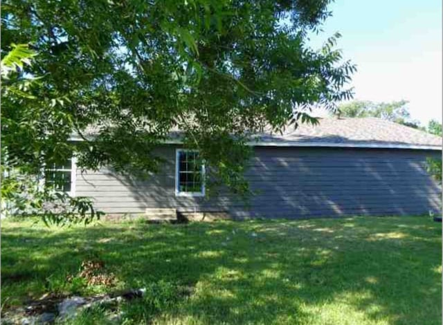 view of side of property featuring a yard