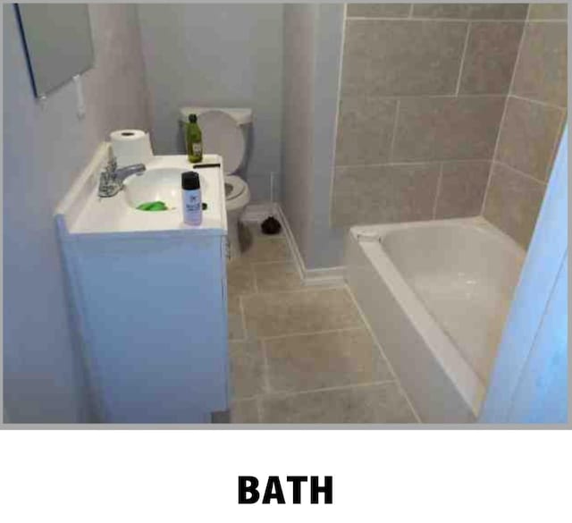 5417 Caplin St, Houston, TX 77026 - full bath with vanity, tile patterned flooring, baseboards, and toilet