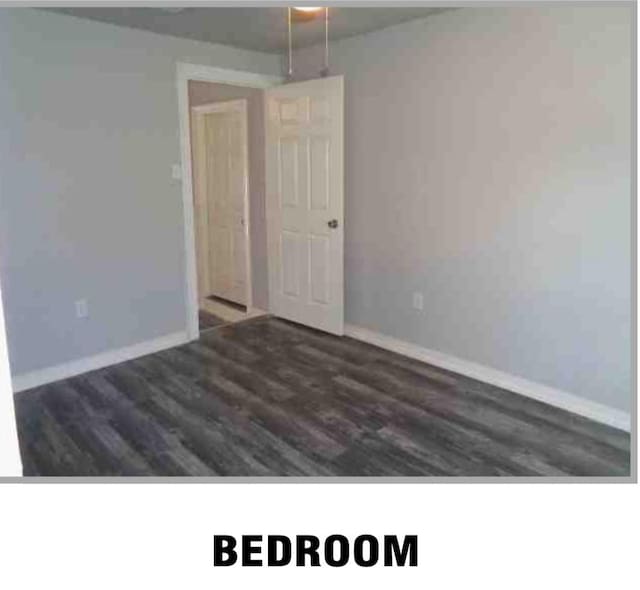 5417 Caplin St, Houston, TX 77026 - unfurnished room with baseboards and wood finished floors