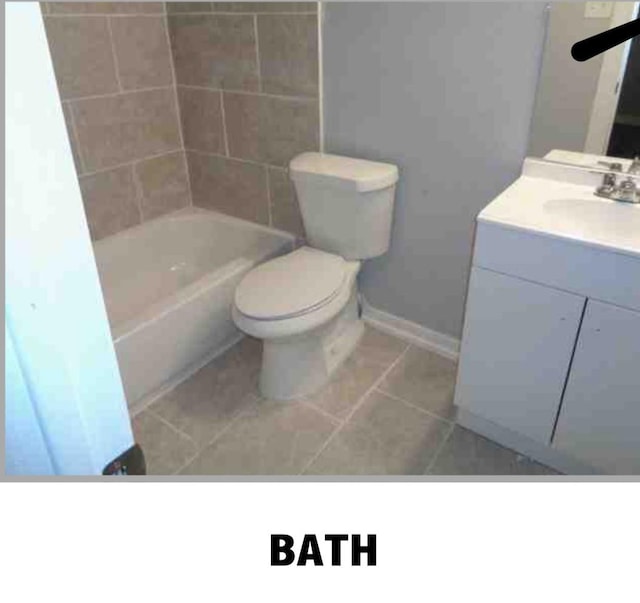 5417 Caplin St, Houston, TX 77026 - bathroom featuring toilet, baseboards, tile patterned flooring, and vanity