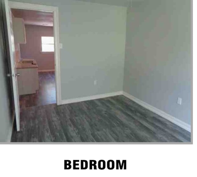 spare room with dark hardwood / wood-style flooring