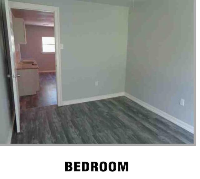 5417 Caplin St, Houston, TX 77026 - unfurnished room with baseboards and wood finished floors