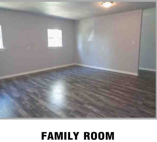 empty room featuring dark wood-type flooring