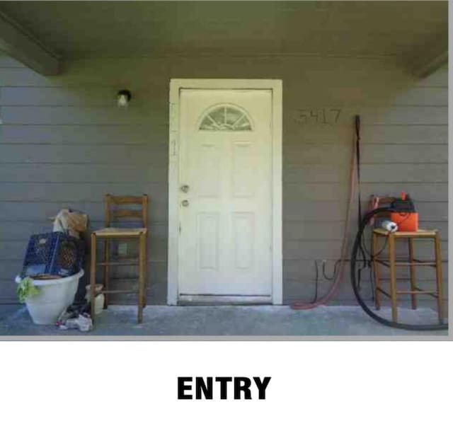 5417 Caplin St, Houston, TX 77026 - doorway to property with covered porch