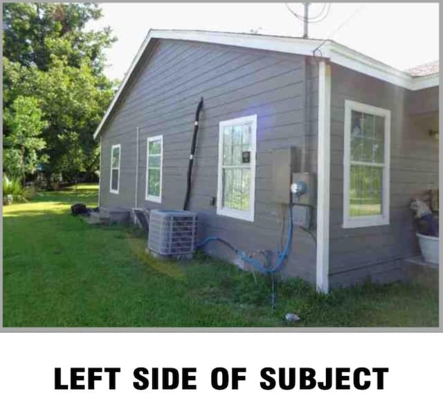 5417 Caplin St, Houston, TX 77026 - view of side of property with central AC and a yard