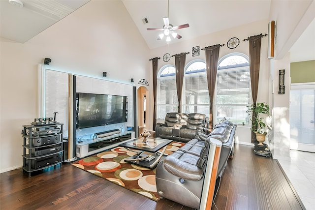 living room with dark wood-type flooring, high vaulted ceiling, and ceiling fan