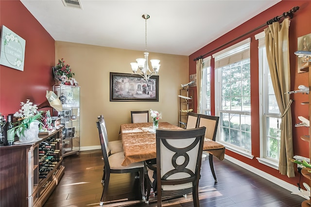 dining space featuring a chandelier and dark hardwood / wood-style floors