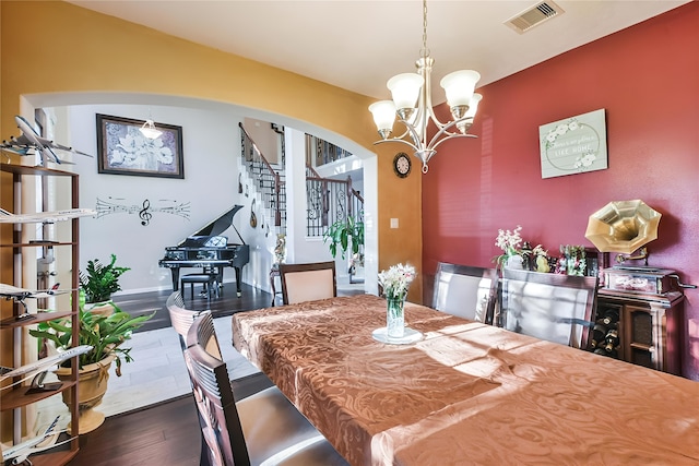 dining area with a chandelier and dark wood-type flooring