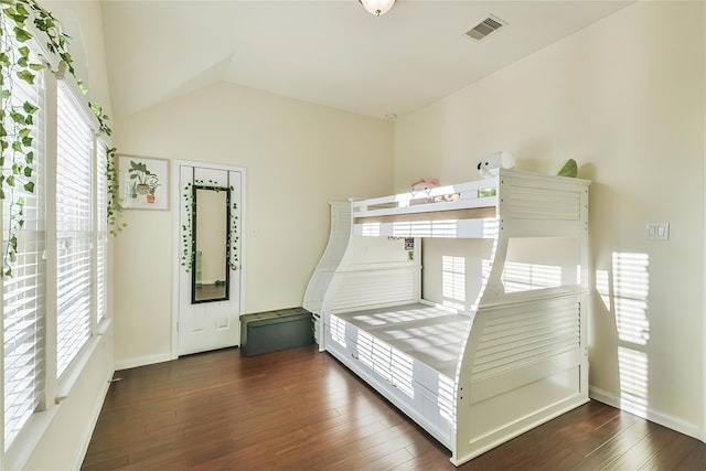 unfurnished bedroom with lofted ceiling and dark hardwood / wood-style floors