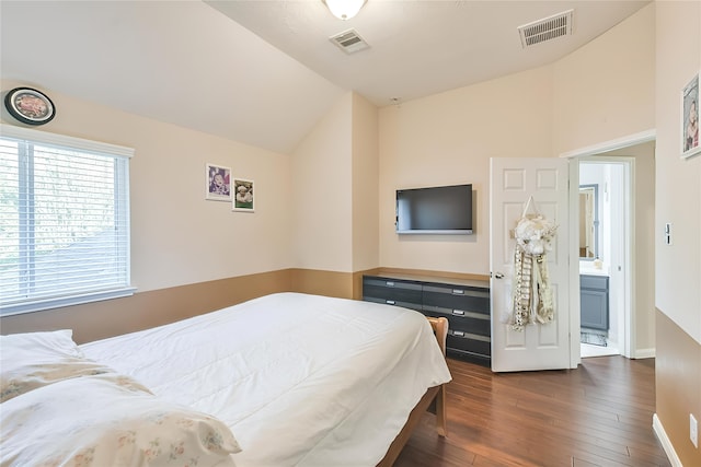 bedroom featuring ensuite bathroom, lofted ceiling, and dark hardwood / wood-style floors