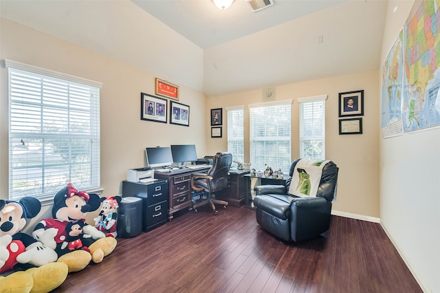 home office with a healthy amount of sunlight, dark hardwood / wood-style flooring, and lofted ceiling