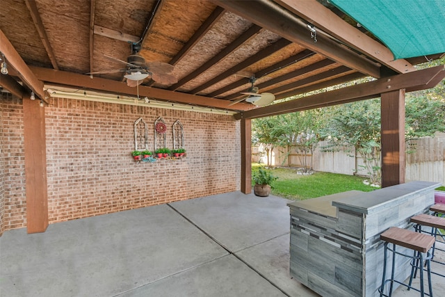 view of patio featuring an outdoor bar and ceiling fan