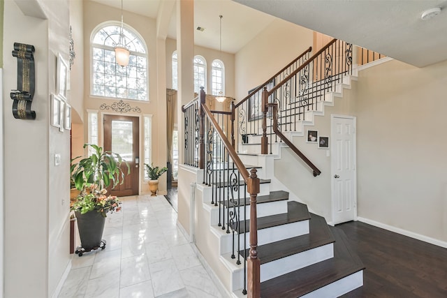 foyer with a high ceiling and a notable chandelier