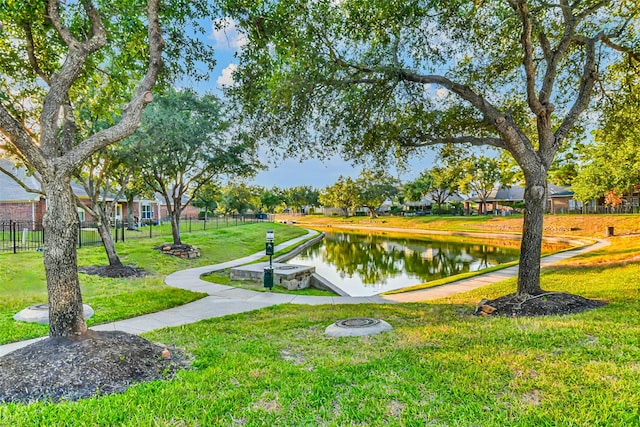 view of home's community with a yard and a water view