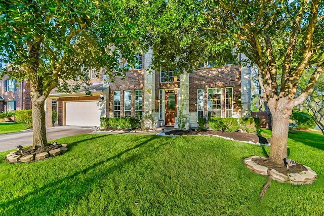 view of front of home with a front yard and a garage