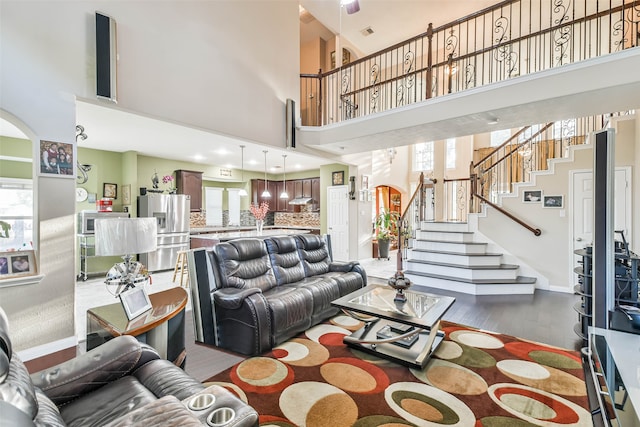 living room with a high ceiling and hardwood / wood-style floors