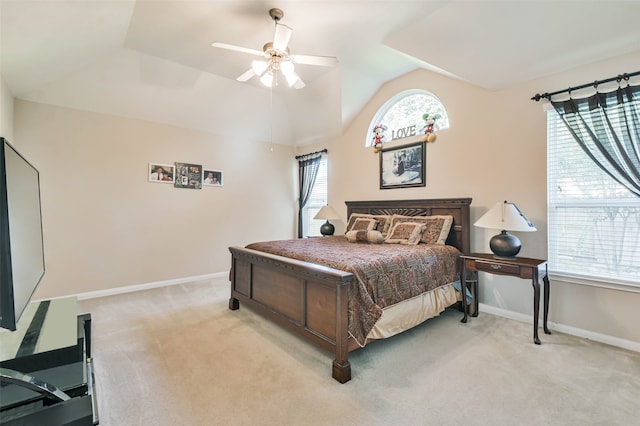 carpeted bedroom featuring ceiling fan, multiple windows, and lofted ceiling