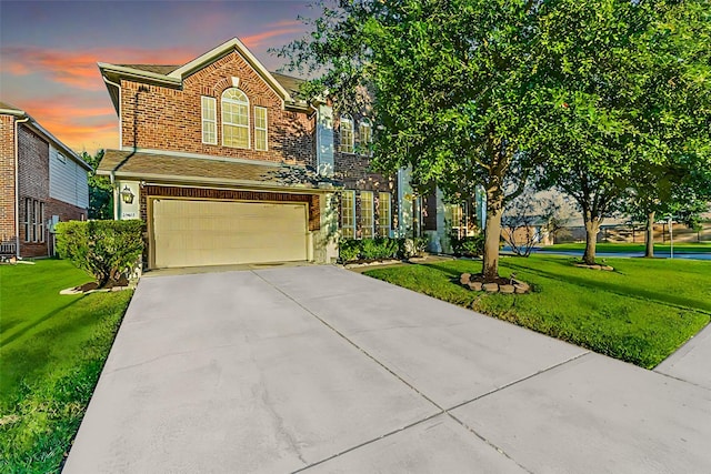 view of front of house with a yard and a garage