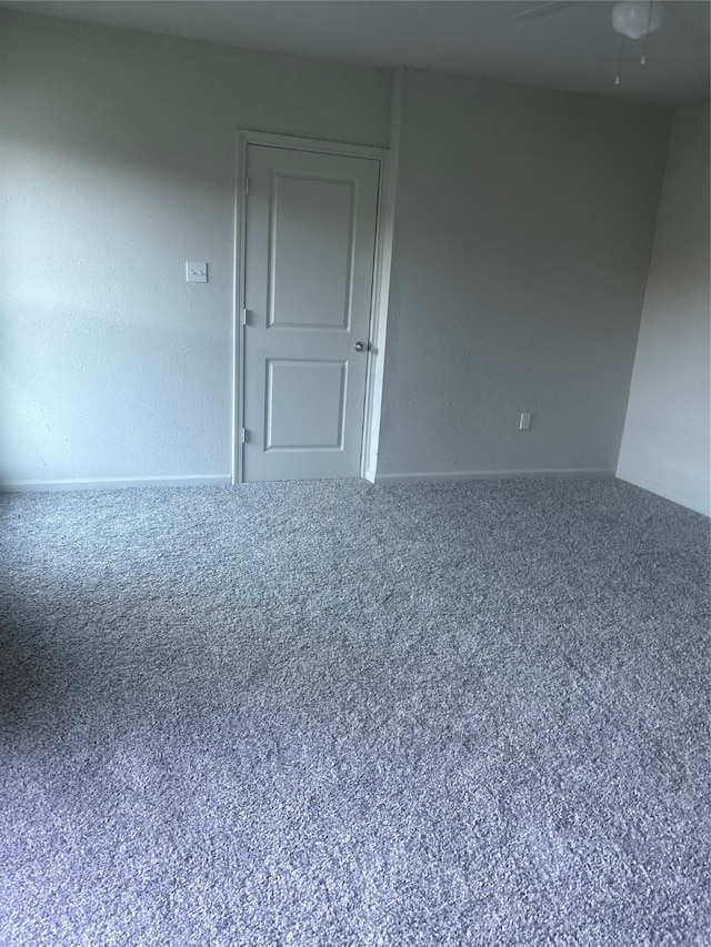 spare room with carpet and ceiling fan