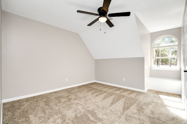 bonus room featuring vaulted ceiling, light colored carpet, and ceiling fan