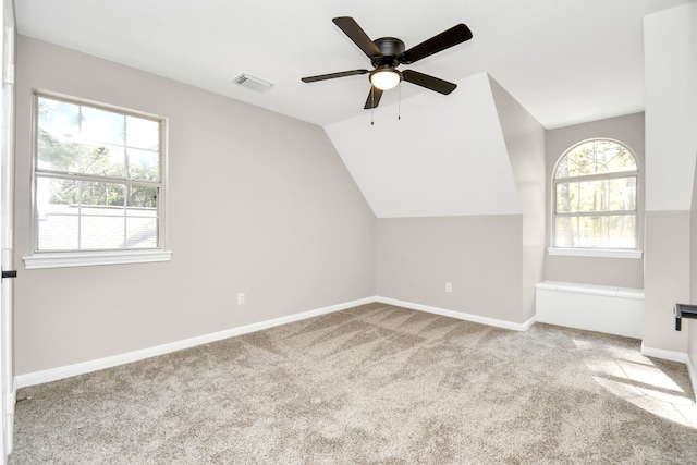 bonus room featuring ceiling fan, lofted ceiling, and light colored carpet