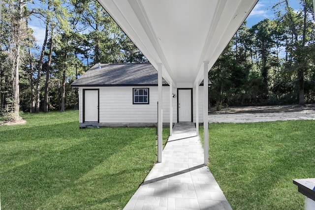 entrance to property with a lawn