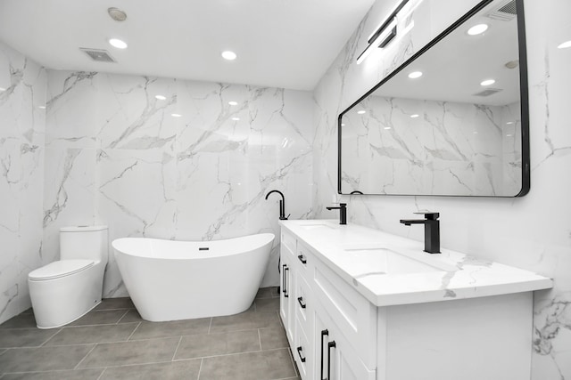 bathroom with vanity, toilet, tile walls, and a tub